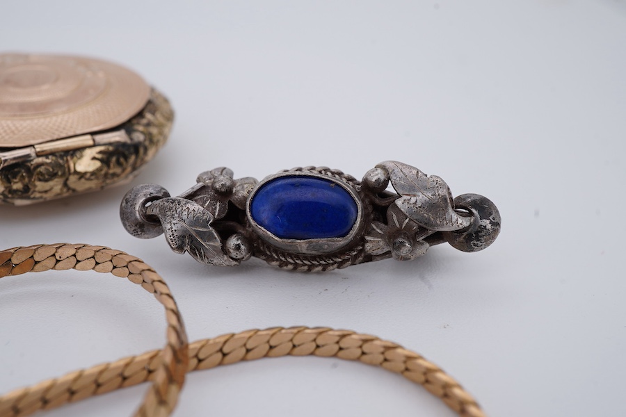 A group of jewels, comprising, a 9ct gold flat curb chain, length 37.5cm, British hallmarks, gross weight 5 grams; a gilt metal locket pendant; an Edwardian gilt metal, green and pink paste brooch; and a silver brooch se